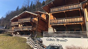 Un chalet en bois doté de balcons et d’une enseigne indiquant « Chalet Brunens ».
