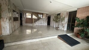 A spacious lobby with marble walls, a staircase, and potted plants. - A1018 - Comfort and tranquility by the sea (Cala de Finestrat)