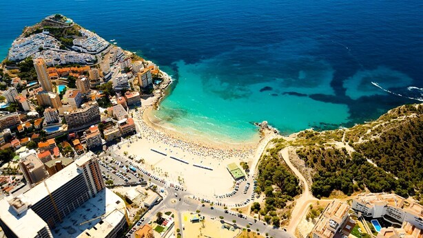 An aerial view of a coastal town with a beach, buildings, and a clear blue sea. - A1018 - Comfort and tranquility by the sea (Cala de Finestrat)