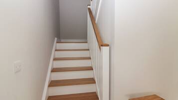 A staircase with wooden steps and white railings.