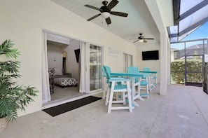 Relax in this serene outdoor space with a seating area and glass door leading to a cozy interior room.
