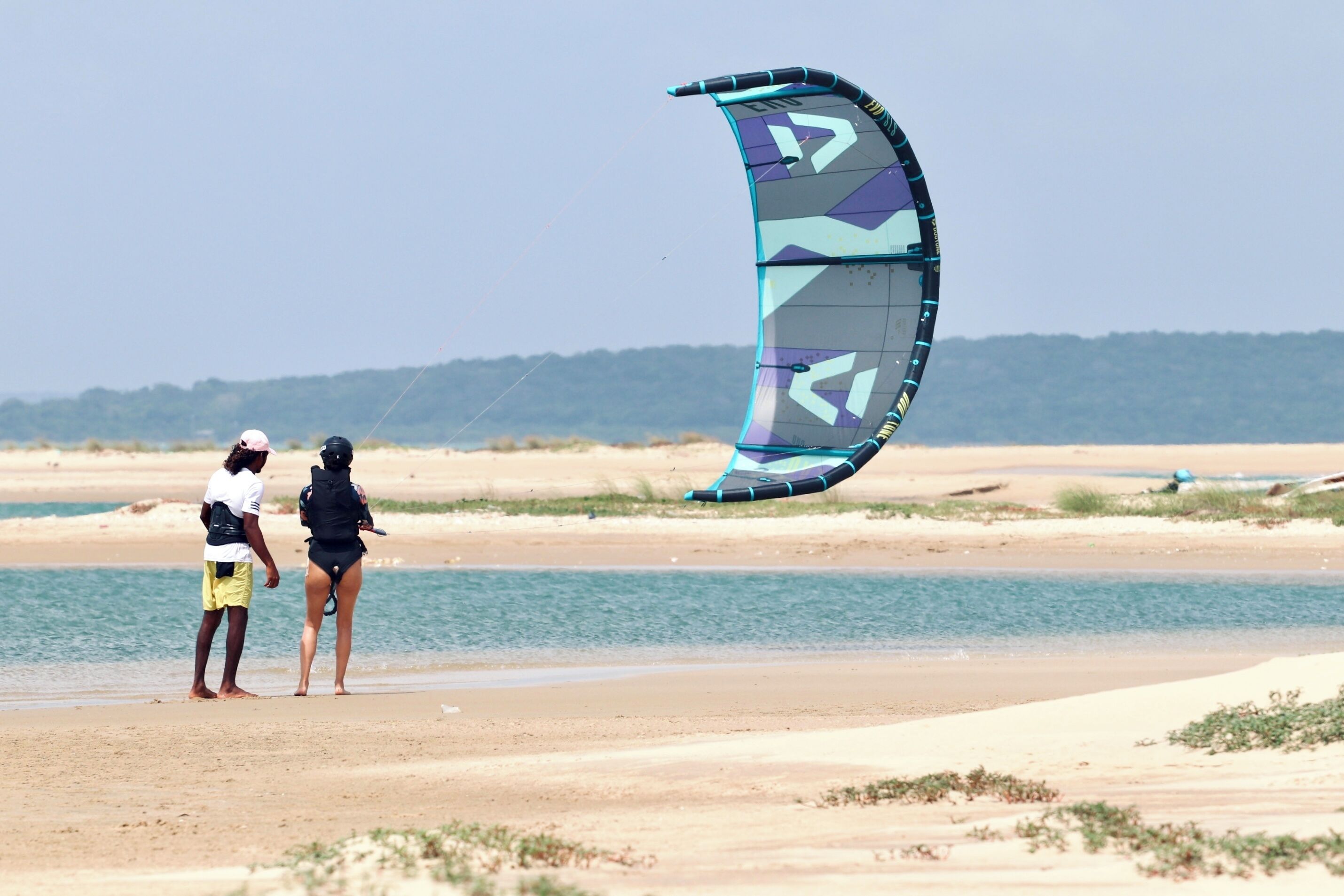 A beach with a large kite.
