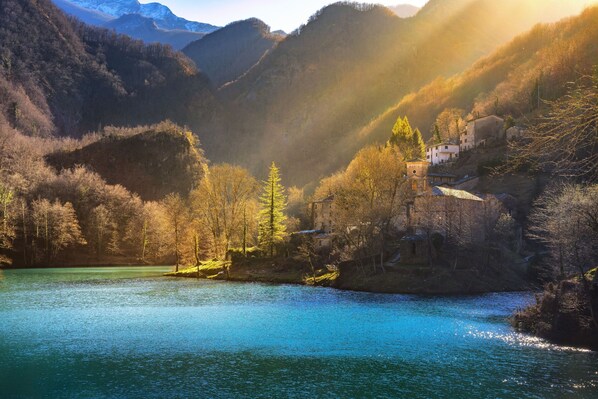A serene lakeside village with traditional architecture nestled among hills. - Family Friendly Rosa House Amazing View (Barga)