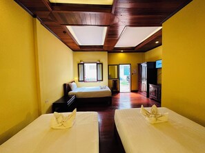 A hotel room with two beds, a large window, a TV, and a wooden ceiling. - Villa Phonethip Mekong Riverside (Luang Prabang)