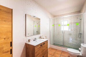 Een bad/douchecombinatie, een bidet, handdoeken