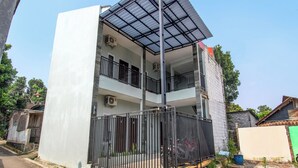 A multi-story building with a flat roof, balconies, and a gated entrance. - OYO 92477 Anugrah Kostel Syariah (Semarang)