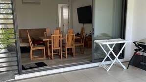 A modern living area with a sliding glass door leading to a dining space. - Impeccable Luxury 3-bed Apartment in Albion (Albion)