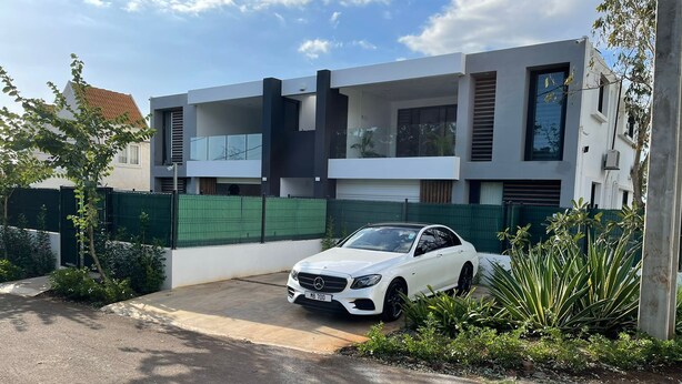 A modern two-story house with a white car parked in the driveway. - Impeccable Luxury 3-bed Apartment in Albion (Albion)