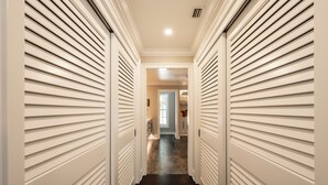 A hallway with white doors and a dark floor.