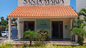 A hotel named Santa Maria with a tiled roof and a sign for Los Secretos restaurant. - SM Apartments (San José del Cabo)