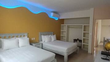 A hotel room with two beds, a wardrobe, a desk, and a globe.