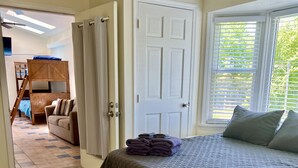 A bedroom with a bed, a door, a window, and a view of another room. - GOTL Winery Mansion- Sunset Vacation Rentals (Geneva)