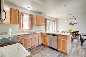 Enjoy meals in this kitchen with a dining area and modern cabinetry.