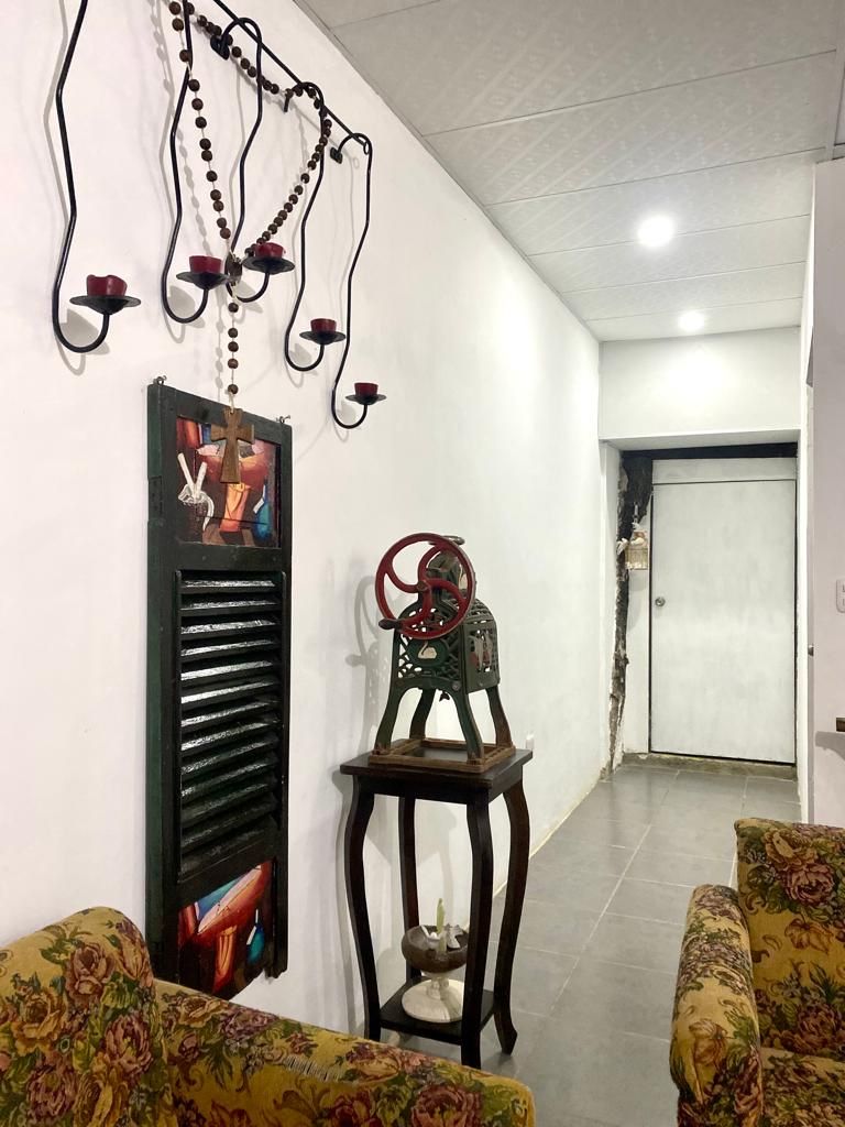 A room with a sofa, a decorative wall piece, and a door in the background.