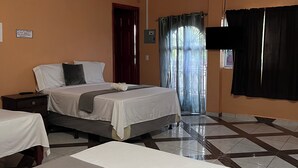 A hotel room with two beds, a flat-screen TV, an air conditioning unit, and a tiled floor. - Hotel y Restaurante La Perla (Cacaopera)