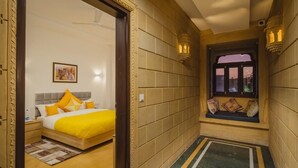 Habitación de hotel con cama, mesita de noche y ventana con vistas al exterior.