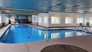 An indoor swimming pool with clear water, a tiled floor, and a ceiling with recessed lighting. - Jack's Cabin-Fall Creek Resort Amenities (Branson)