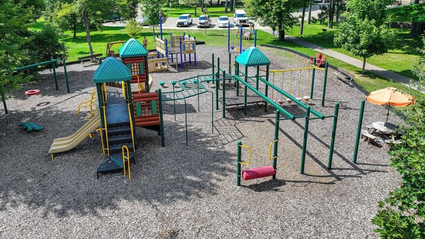 A playground with various play structures, a picnic area, and a parking lot in the background. - 4-Season Anglers Cabin At Shawano Lake w/ Views! (Shawano)