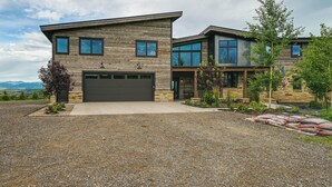 A modern two-story house with a garage, a gravel driveway, and a landscaped garden. - Steamboat Springs Apt w/ Views, 15 Mi to Skiing! (Steamboat Springs)