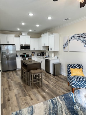 Enjoy cooking and dining in this well-equipped kitchen with a dining table, sink, and appliances.
