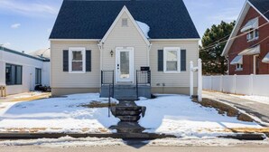 A single-story house with a dark roof, a front porch, and a mailbox. - The Lewis & Clark Hangout (Saint Charles)