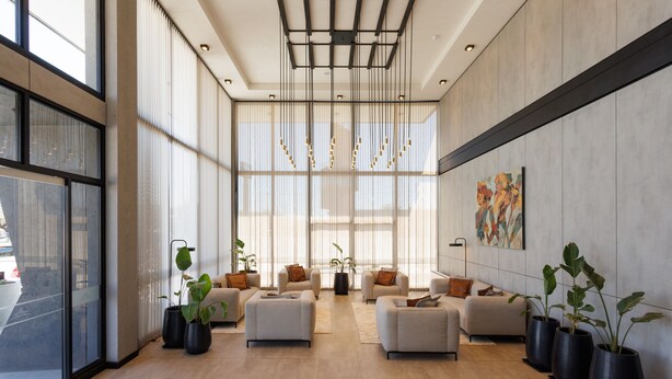 A spacious lobby with large windows, modern furniture, and a unique ceiling design. - Fuente Mayor Hotel Terminal (Mendoza)