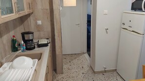 A compact kitchen with a sink, a microwave, and a refrigerator. - Comfortable, friendly, fully equipped apartment (Athina)