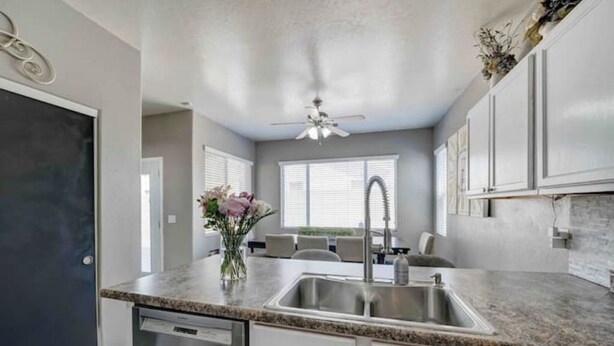 A kitchen with granite countertops, stainless steel appliances, and white cabinetry. - Sandstone Bliss - 3 bed, 2.5 Bath Cozy Home! (Mesa)