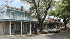 A two-story building with a balcony on the ground floor.