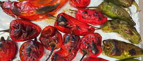 A variety of roasted peppers on a tray.