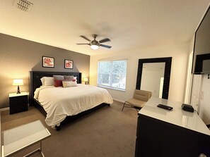 Relax in a stylishly designed room with a comfortable bed, desk, and chair.