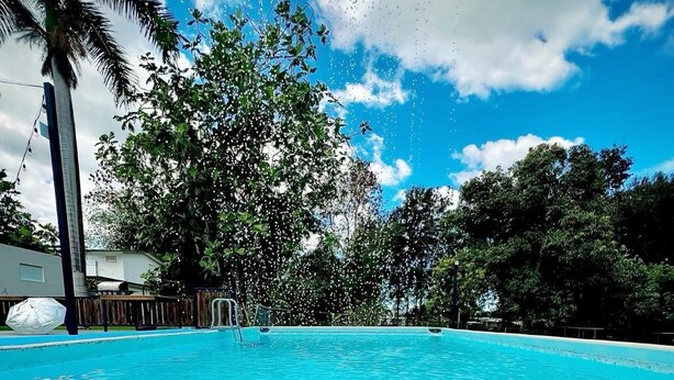 A clear blue pool surrounded by trees and a clear sky. - EcoMar Rentals #1: Cabo Rojo, Puerto Rico; Beach & Pool (Cabo Rojo)