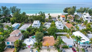 A coastal residential area with houses, some with pools, and a beach in the background. - 200 steps to the Beach | Heated pool + spa (Holmes Beach)