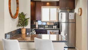 A modern kitchen with a central island, stainless steel appliances, and a large mirror. - Riviera Bay View Dream - Private Patio with Bay View, Parking & W/D! (San Diego)