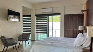 A bedroom with a bed, a chair, a desk, and a wardrobe. - Casa Boutique Maria Bonita  (La Manzanilla)