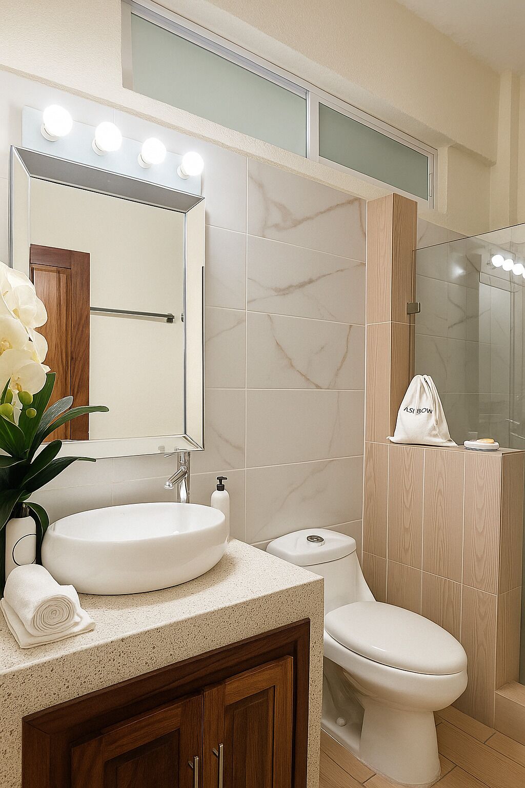 A modern bathroom with a vanity, sink, mirror, and toilet.