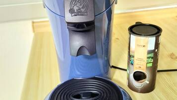 A blue Philips Senseo coffee maker with a coffee pod holder beside it.