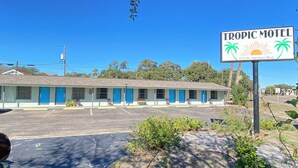 A two-story motel with blue doors and a signboard. - Tropic Motel (Aransas Pass)