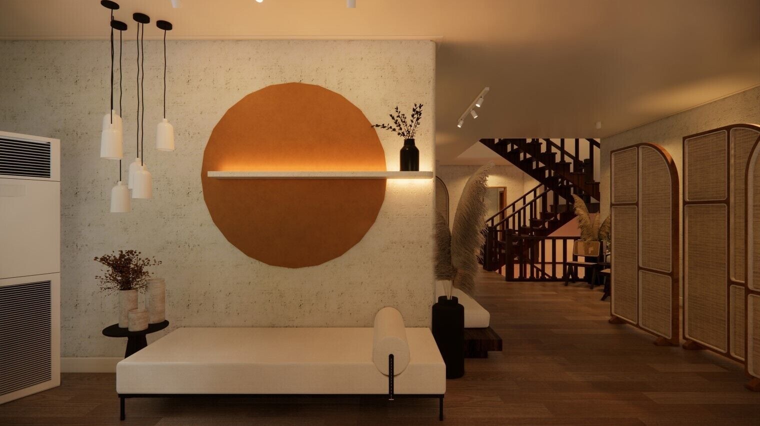 A modern interior with a large circular wall feature, a sofa, a small table with candles, and a staircase in the background.
