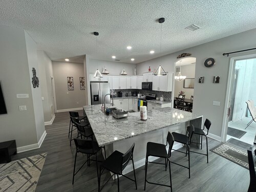 Modern and spacious getaway with a pool and grill