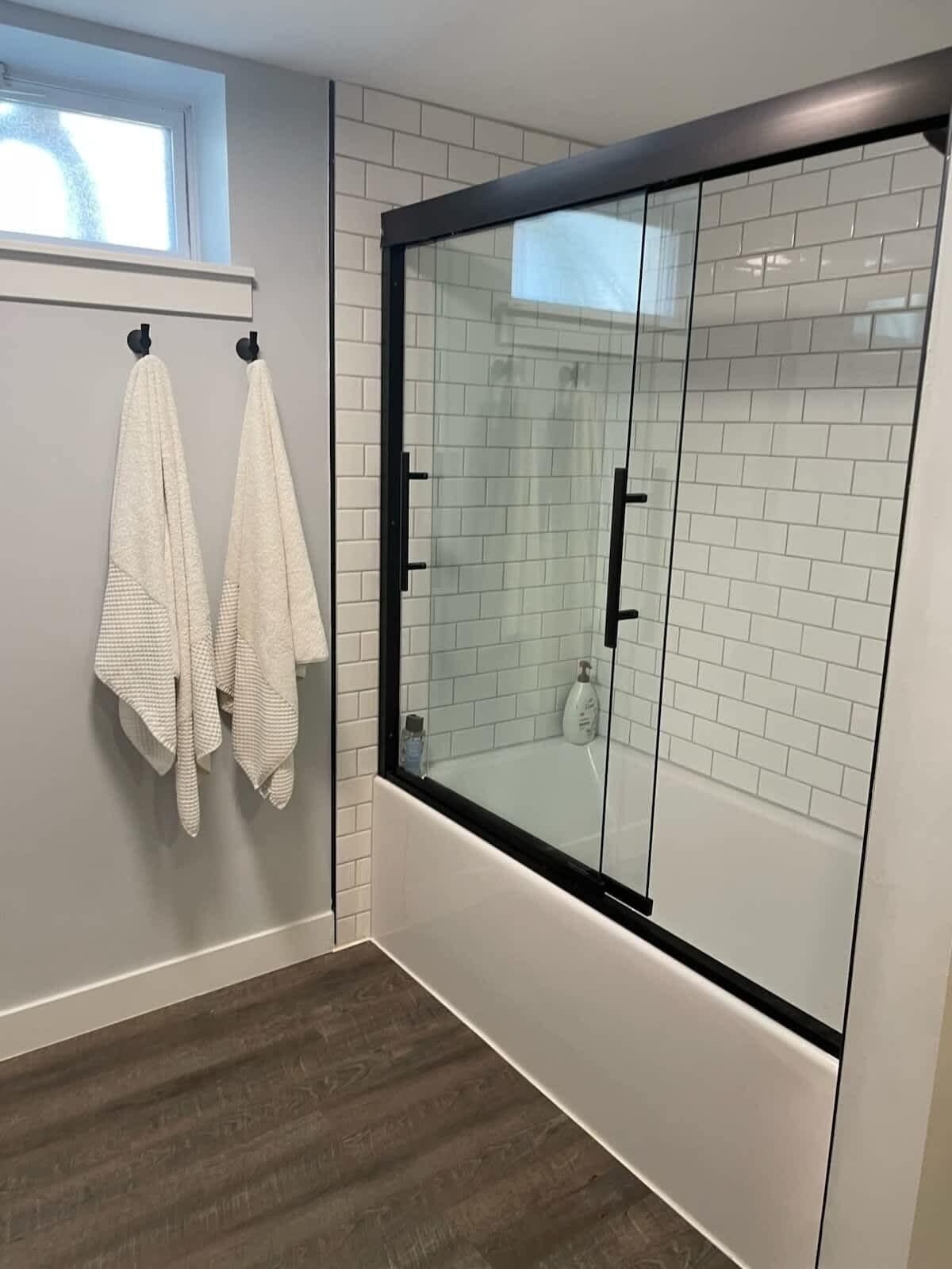 Bathtub, hair dryer, towels, shampoo