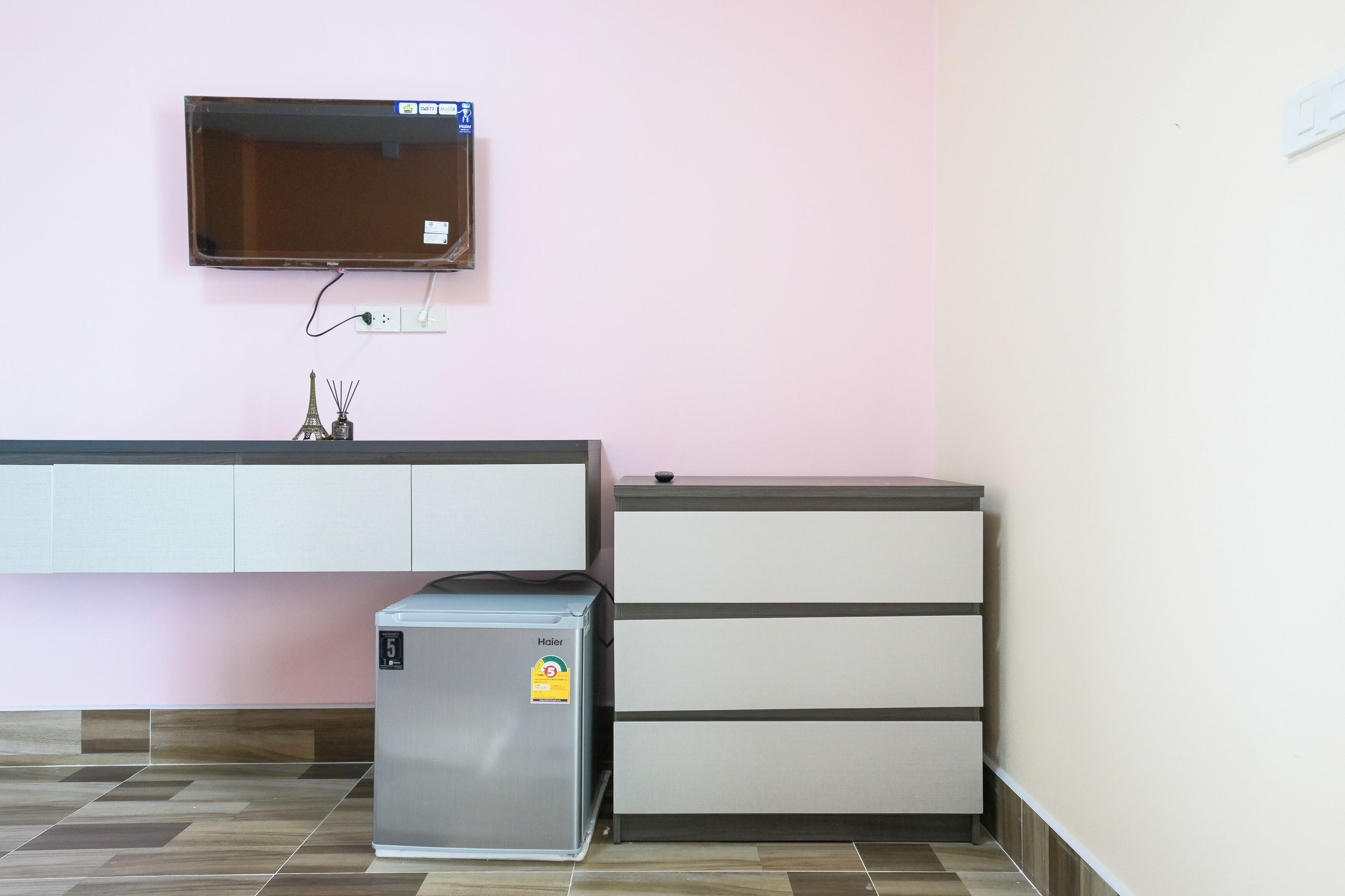 A kitchenette with a refrigerator, a microwave, and a built-in oven.