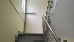 A staircase with metal railings and a handrail, leading to an upper floor. - Rivoli Hotel (San Pablo)