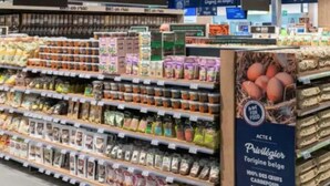 A grocery store aisle with various packaged food items on shelves.