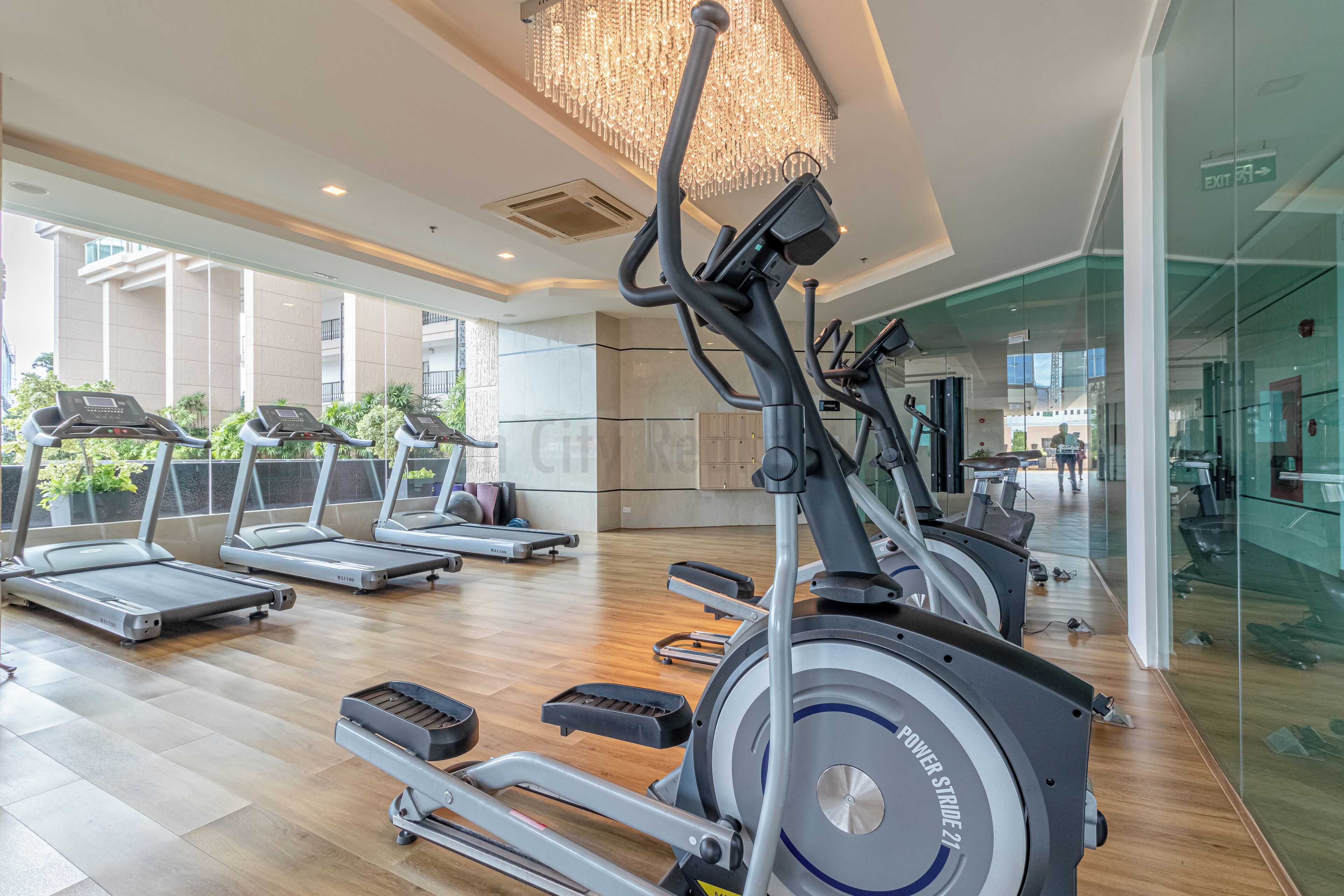 A gym with multiple treadmills, stationary bikes, and a rowing machine.