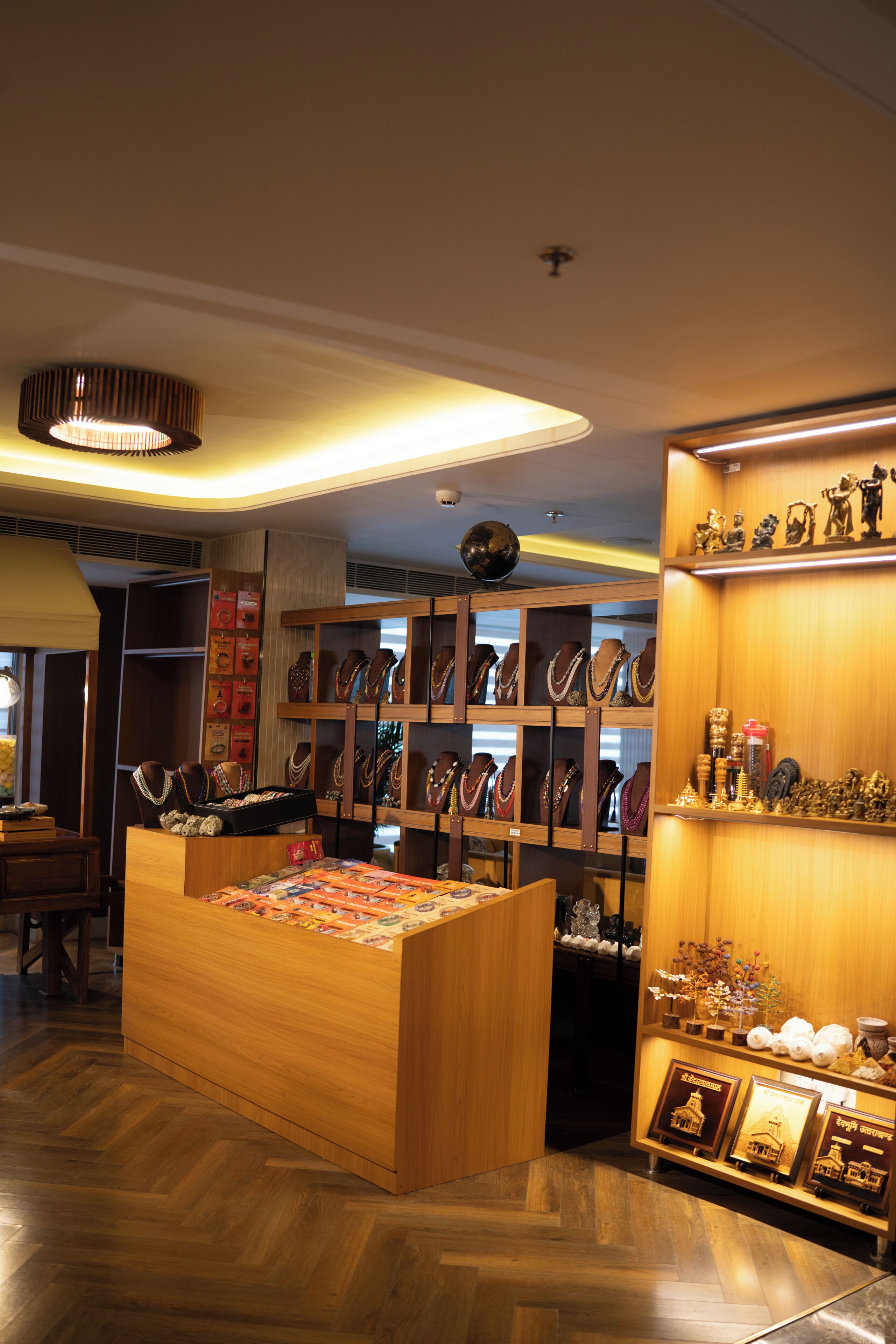 A jewelry store with wooden display cases and a central counter.