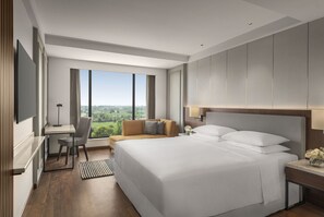 A modern hotel room with a large bed, a desk, and a view of the city. - Hyatt Place Haridwar (Haridwar)