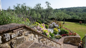 A stone staircase leading to a garden with various plants and flowers. - Tuscany Siena Florence Chianti Swimming pool Felsina Brancaia tenuta Arceno. (Toscana)