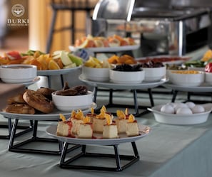 A buffet with various food items including pastries, fruits, and desserts. - Burki Castle & Cellar (Kvareli)