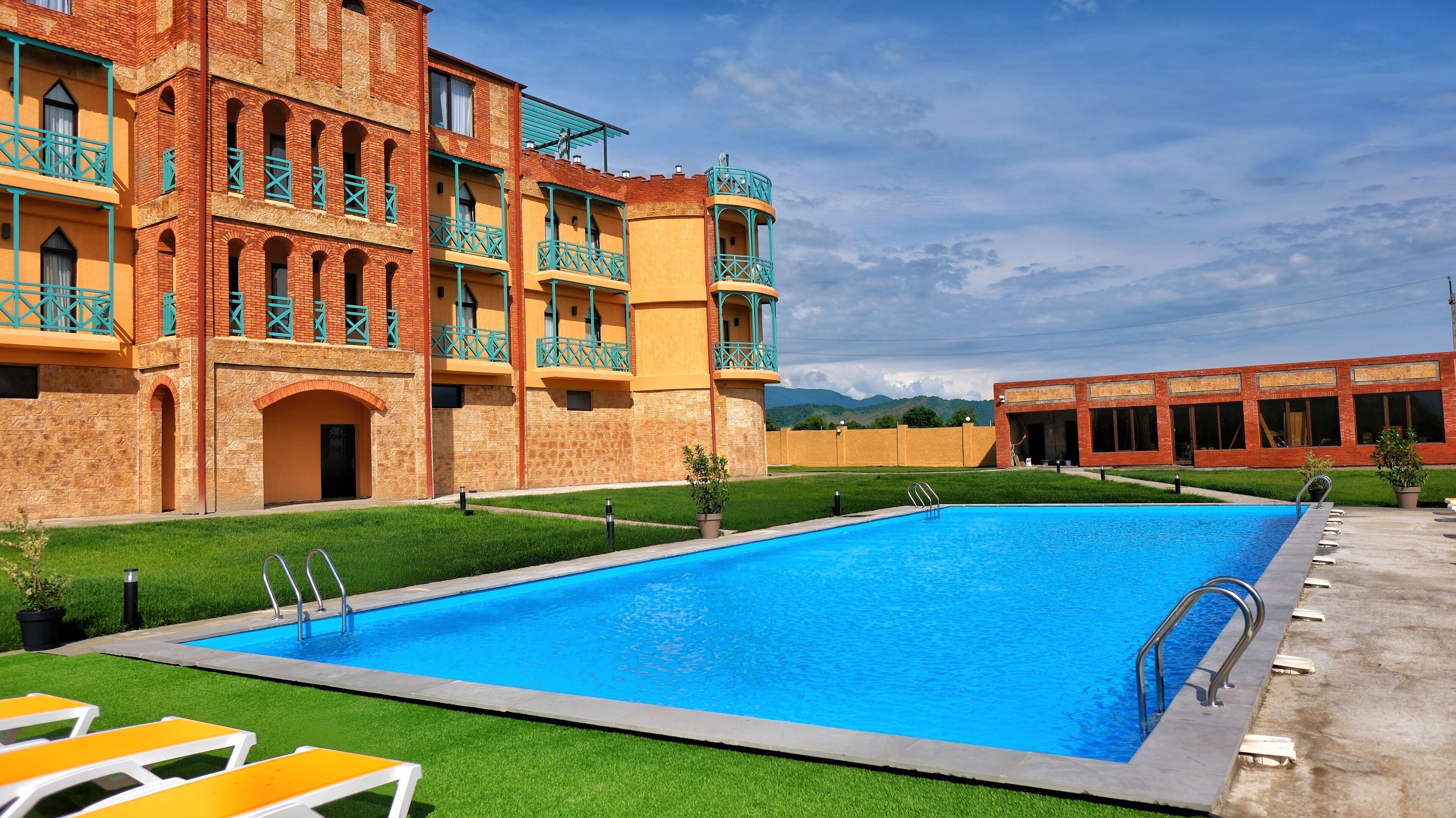 Seasonal outdoor pool, open 10:00 AM to 10:00 PM, pool umbrellas